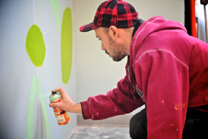 Street artist Milo Tchais' spray paint wall mural at Tootoomoo Crouch End restaurant